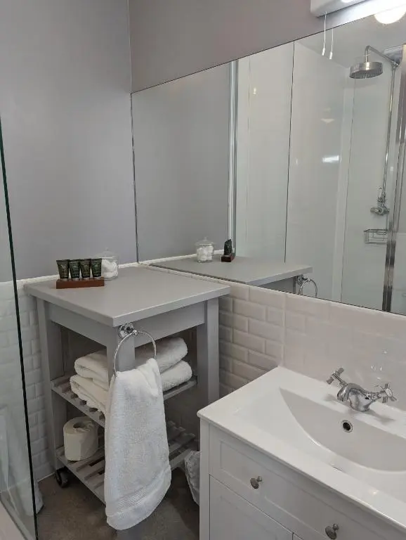 a white bathroom with a sink and a mirror at Furain in Peterculter
