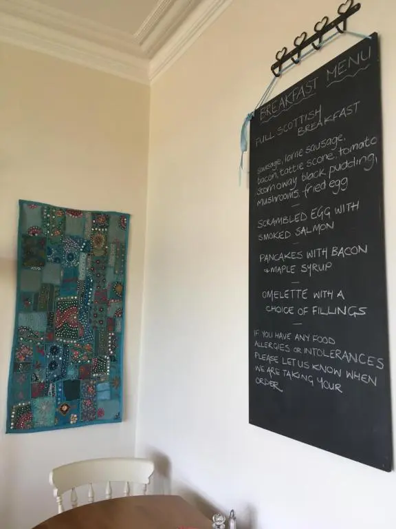 a chalkboard hanging on a wall with a table at Furain in Peterculter