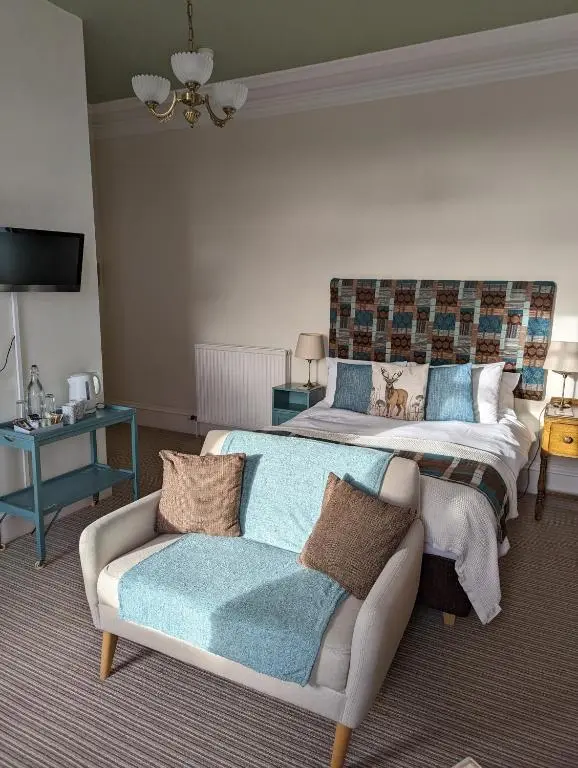 a bedroom with two beds and a couch at Furain in Peterculter