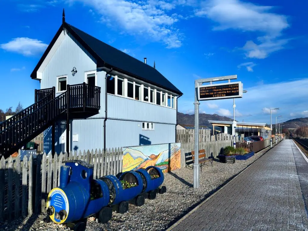 a blue fire hydrant in front of a building at Signal Box in Newtonmore