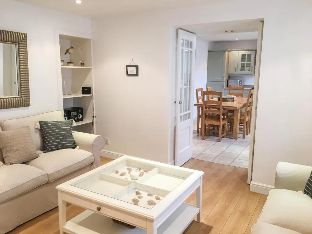 a living room with a couch and a table at 85 Seatown in Cullen