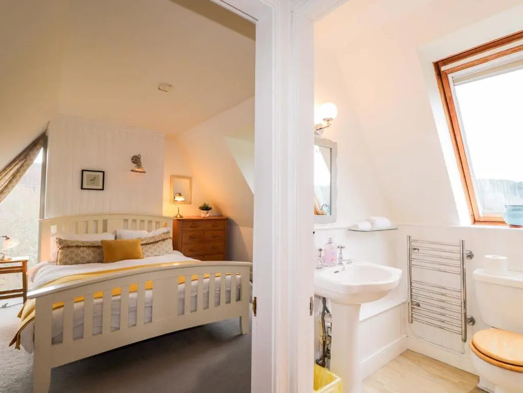 a white bedroom with a bed and a sink at Inshcraig in Kincraig