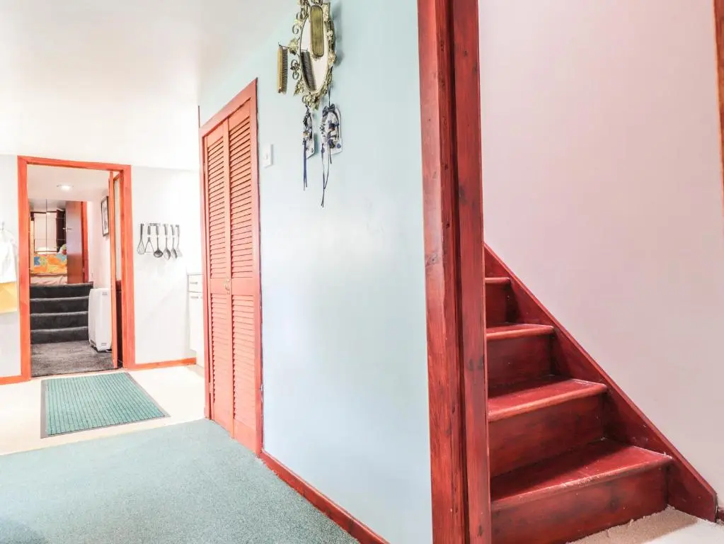 a hallway with a stairway leading into a house at Blairgorm Croft in Nethy Bridge
