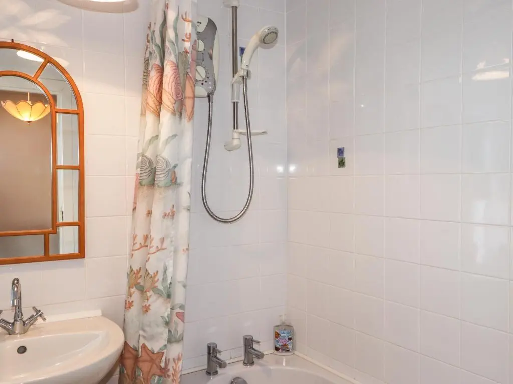 a bathroom with a shower and a sink at Holly Hoose in Findochty