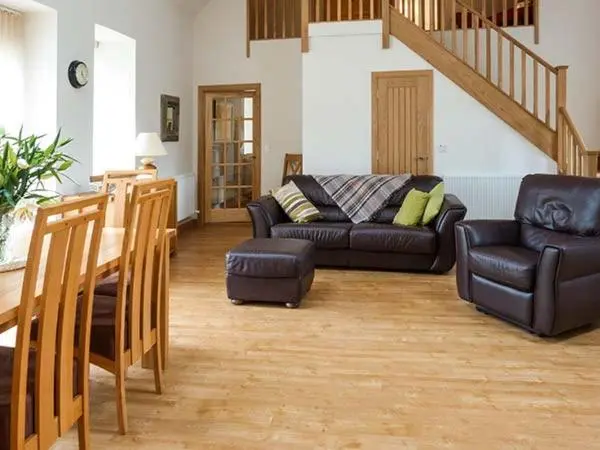 a living room with a couch and a table at The Auld Kirk in Forsinain
