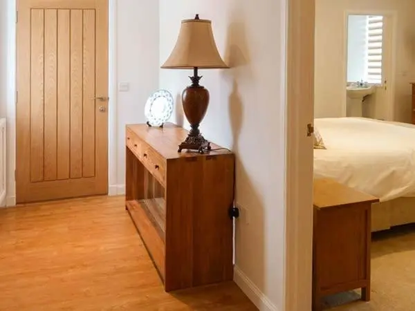 a bedroom with a bed and a lamp on a dresser at The Auld Kirk in Forsinain