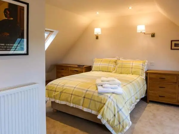 a bedroom with a bed with towels on it at The Auld Kirk in Forsinain