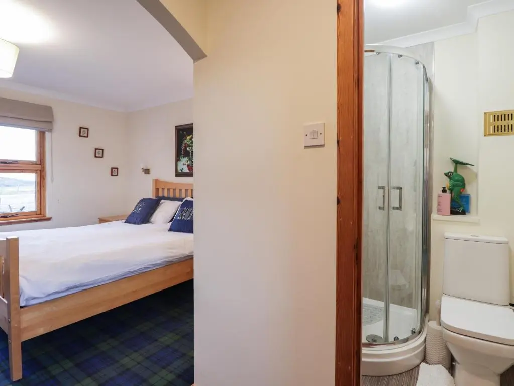 a bedroom with a bed and a shower at Bogairn in Carron