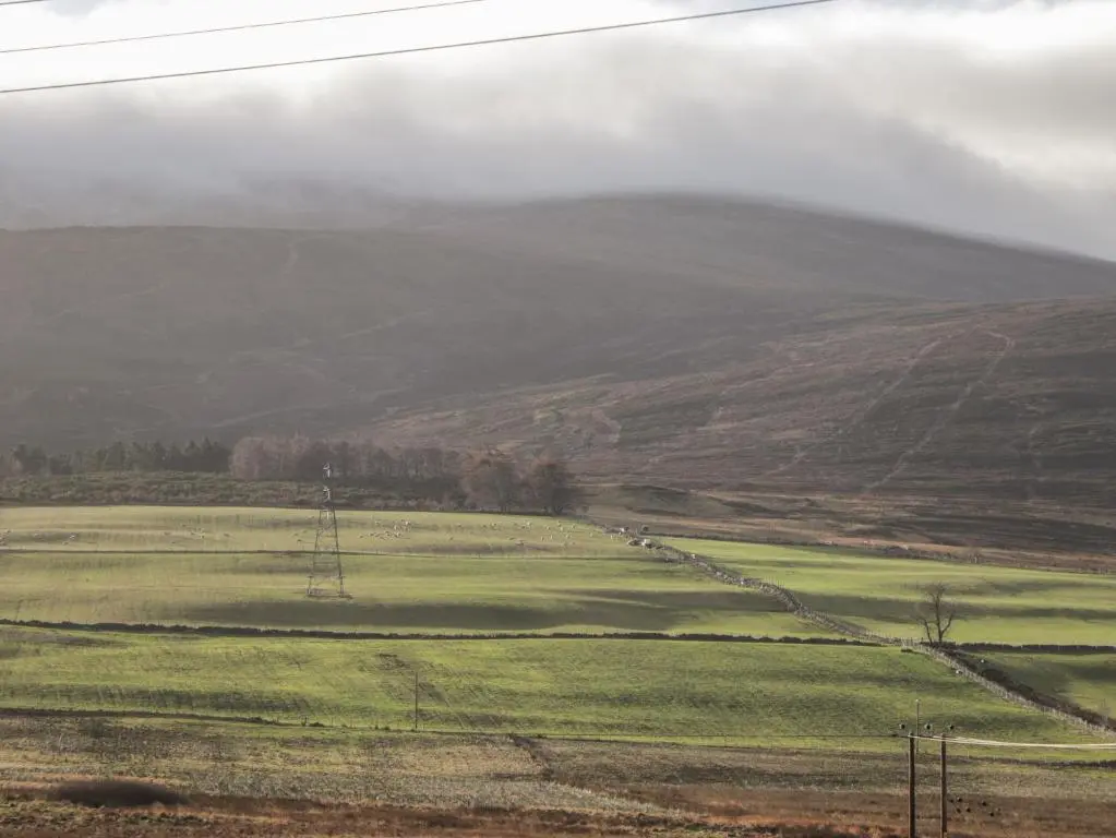 a green field with a hill in the background at Bogairn in Carron