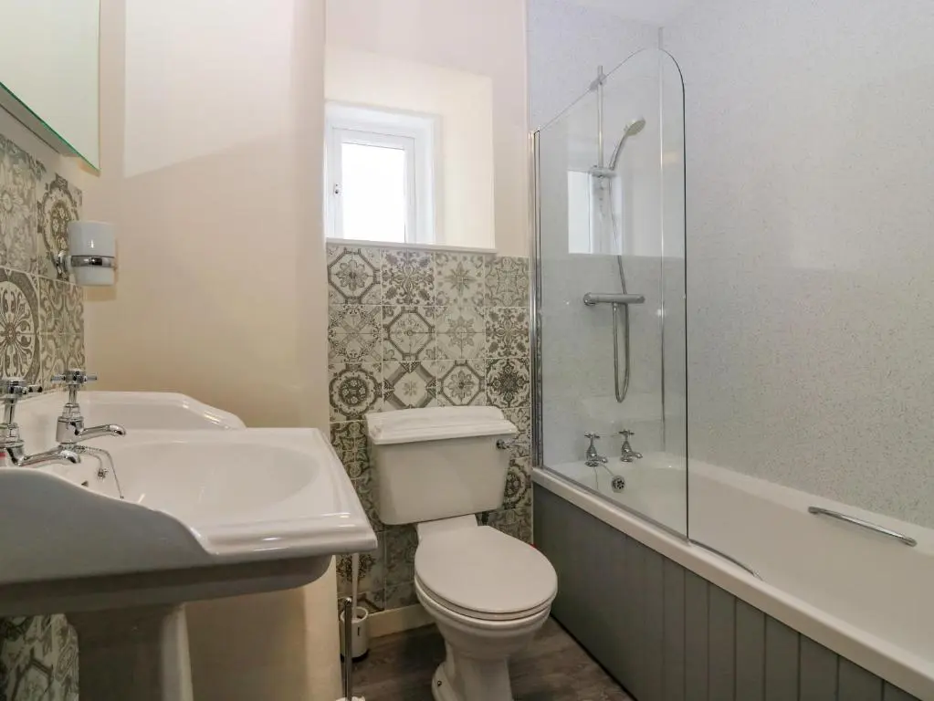 a bathroom with a toilet and a sink and a shower at The West Wing in Skye of Curr