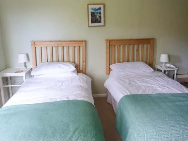 two beds sitting next to each other in a bedroom at Fronthill in Newtonmore
