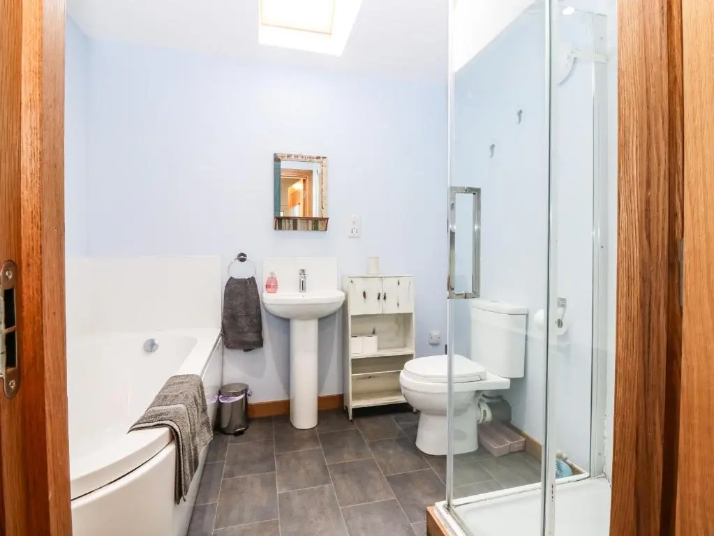 a bathroom with a toilet and a sink and a shower at 49 Crovie Village in Gardenstown