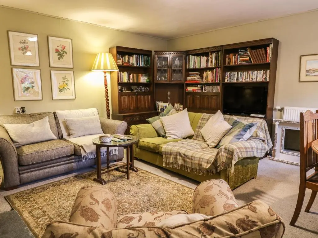 a living room with two couches and a tv at Coorie Doon in Nairn