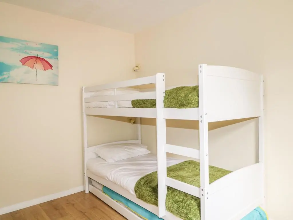 a bunk bed room with a white bunk bed at 79 Corrour Road in Aviemore