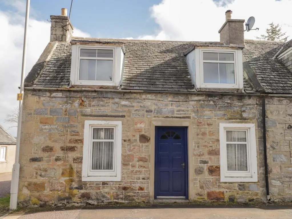 an old stone house with a blue door at Alt na Voir in Tomintoul