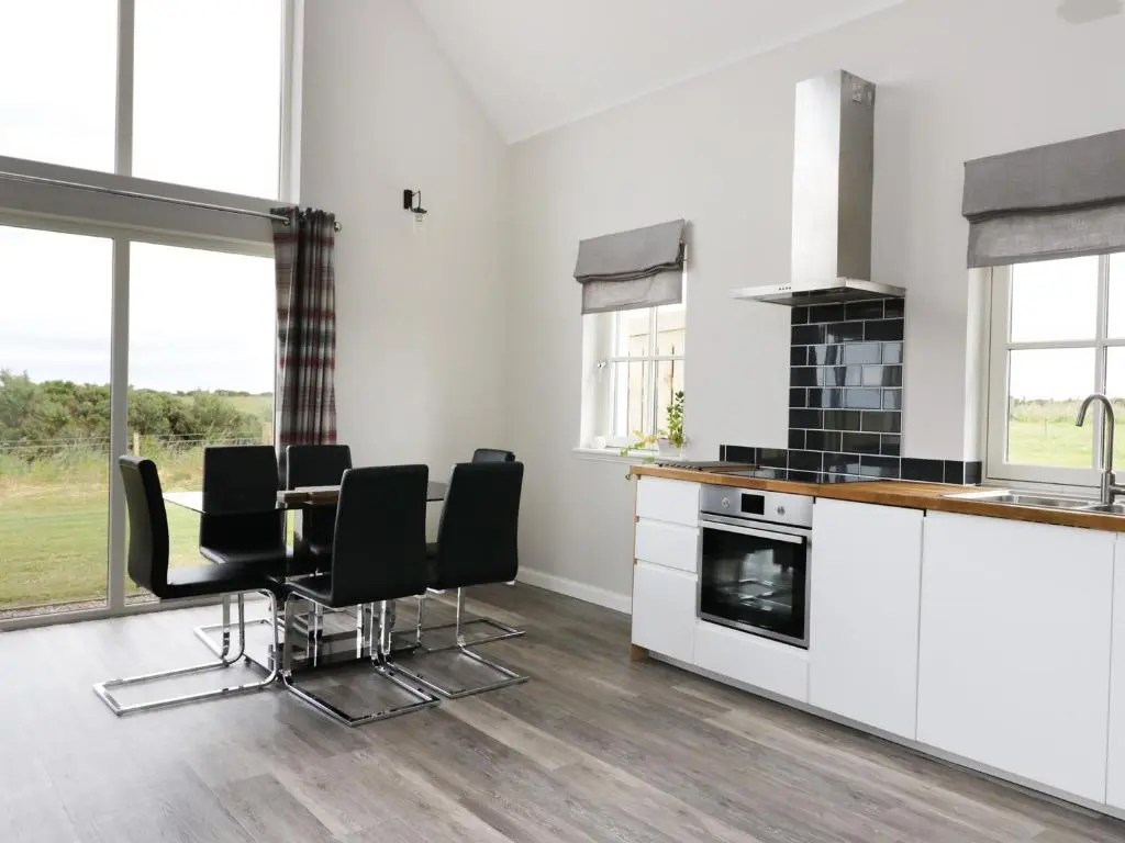 a kitchen and dining room with a table and chairs at Chance Inn Lodge in Balmedie