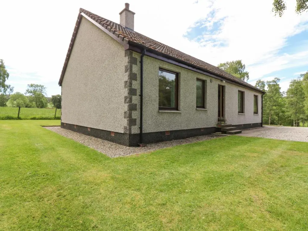 a small house with a grass yard in front of it at Birchbank in Skye of Curr