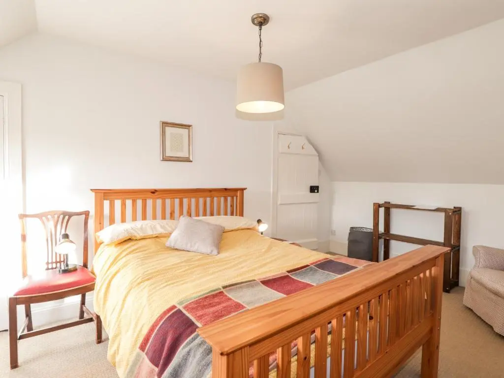a bedroom with a bed and a couch and a chair at 59 Society Street in Nairn