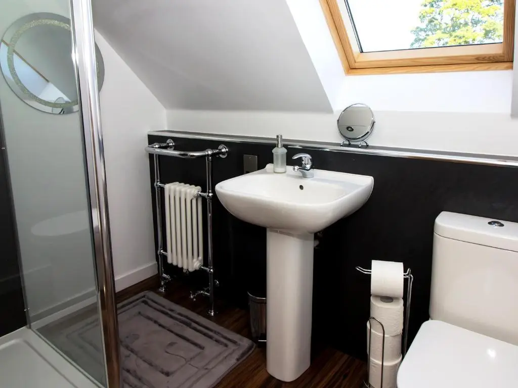 a bathroom with a sink and a toilet and a shower at Nef-Stedi in Kirktown of Bourtie
