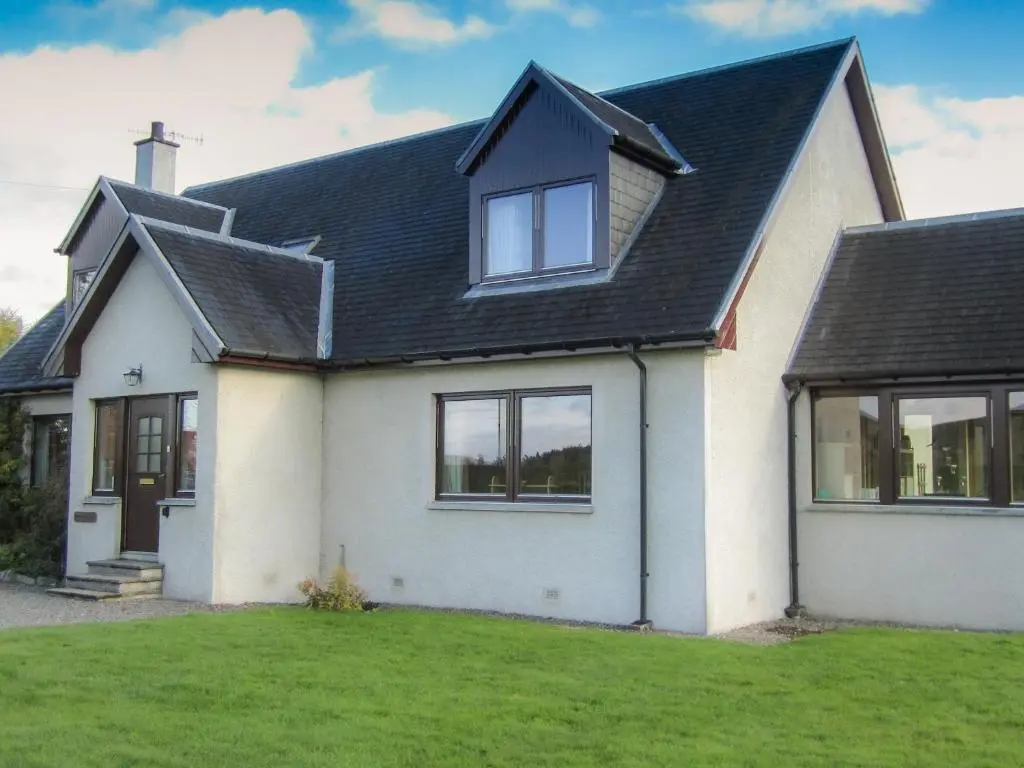 a white house with a black roof at Corriemhor Beag in Cromdale