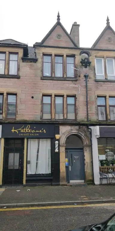 an old brick building with a sign on it at Ness Central Apartment - Greig Street in Inverness