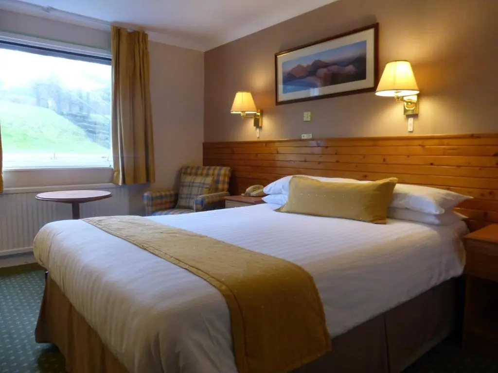 a hotel room with a large bed and a window at Norseman Hotel in Wick