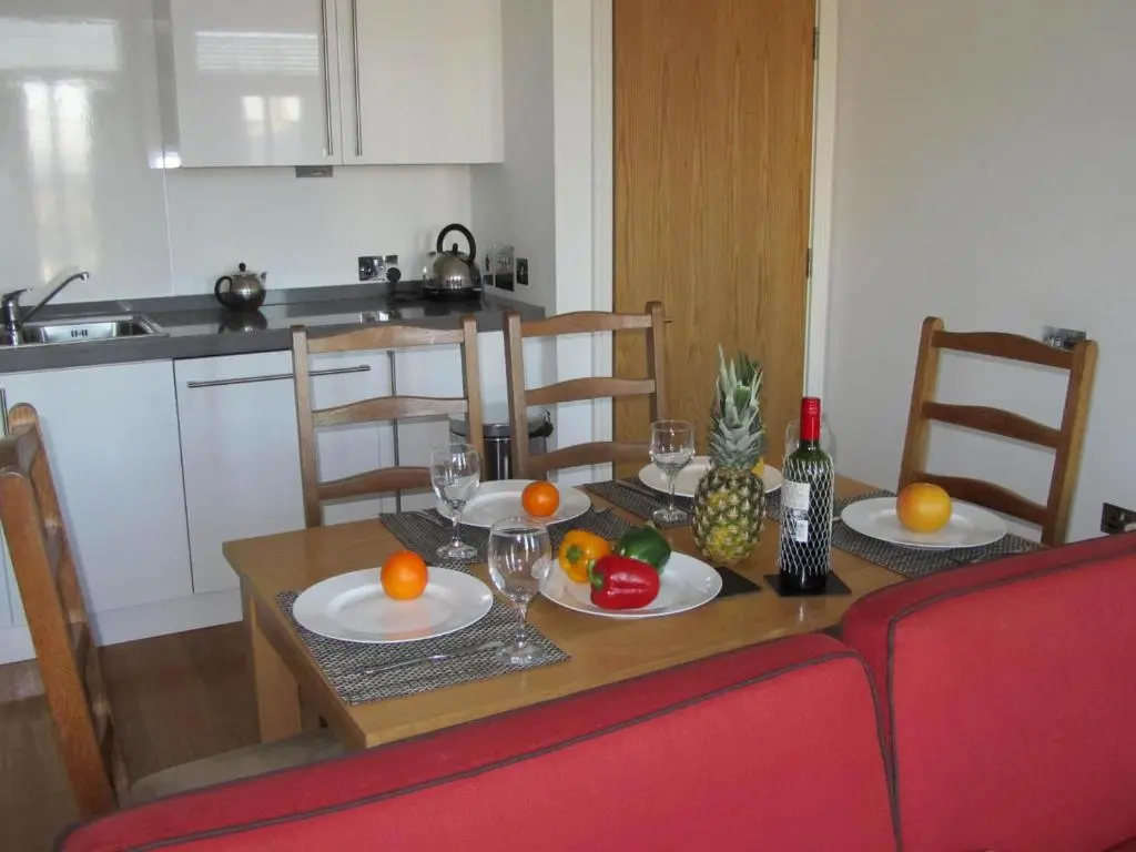 a dining room table with fruit on top of it at Bridge Street Apartments in Inverness