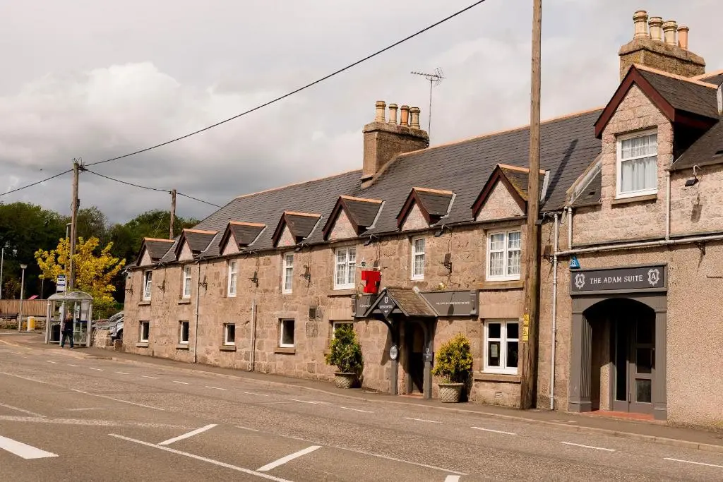 a row of brick buildings on the side of a street at Leys Hotel in Aberdeen