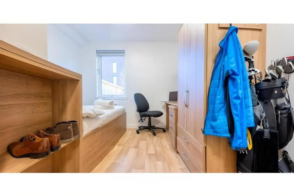 a room with a blue jacket hanging on a wall at UHI Dornoch- Campus Accommodation in Dornoch