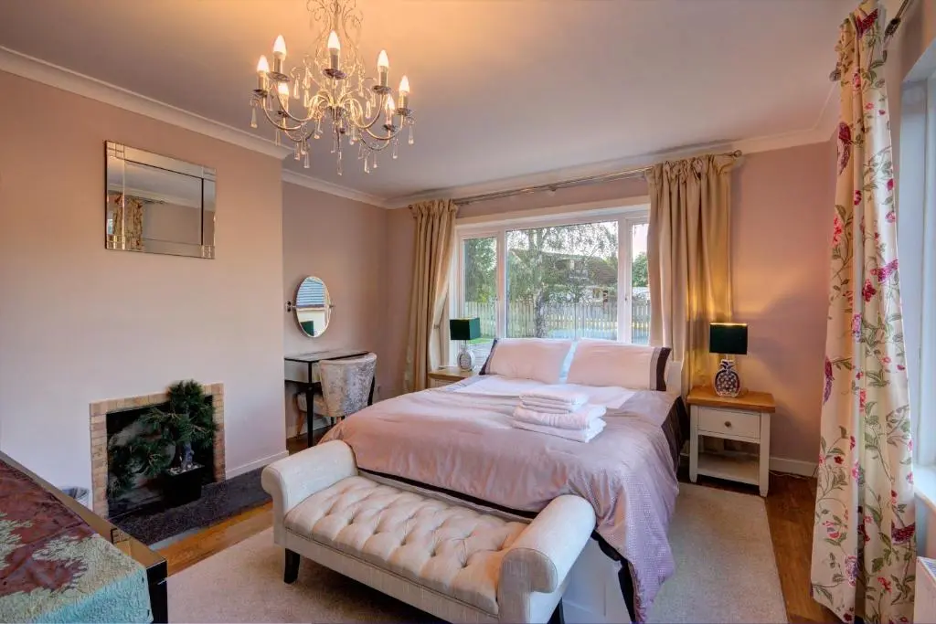 a bedroom with a bed and a chandelier at Loch Earn in Inverness