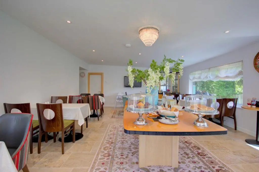 a dining room with a table with food on it at Loch Earn in Inverness