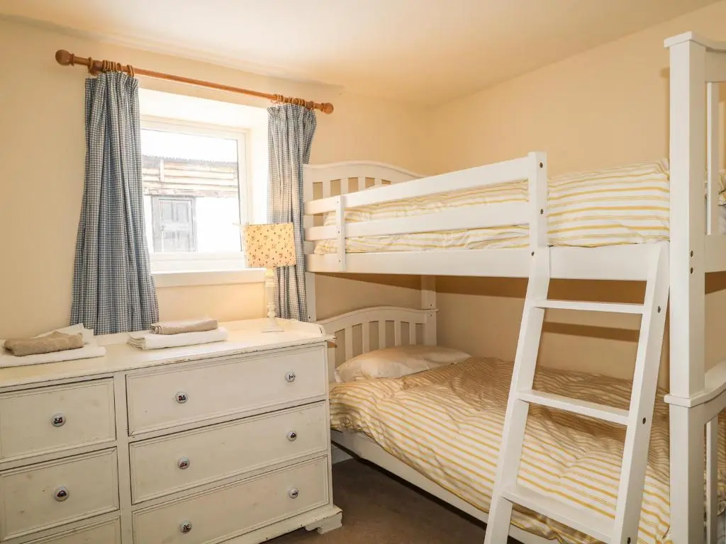 a bedroom with a bunk bed and a bunk ladder at Newlands in Archiestown