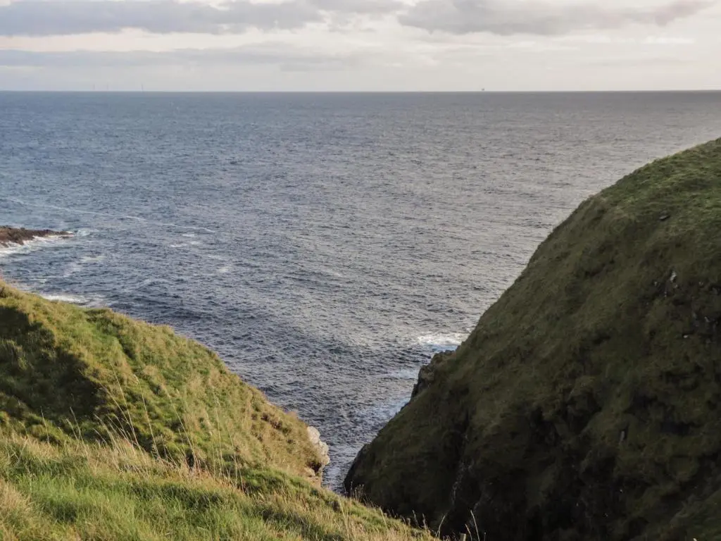a view of the ocean from a cliff at Rose Cottage in Lybster