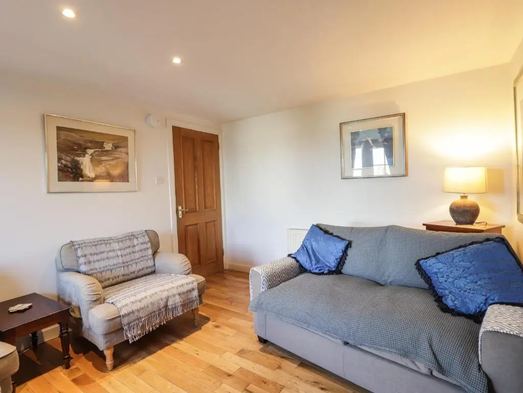 a living room with a couch and a chair at Seaview in Nairn