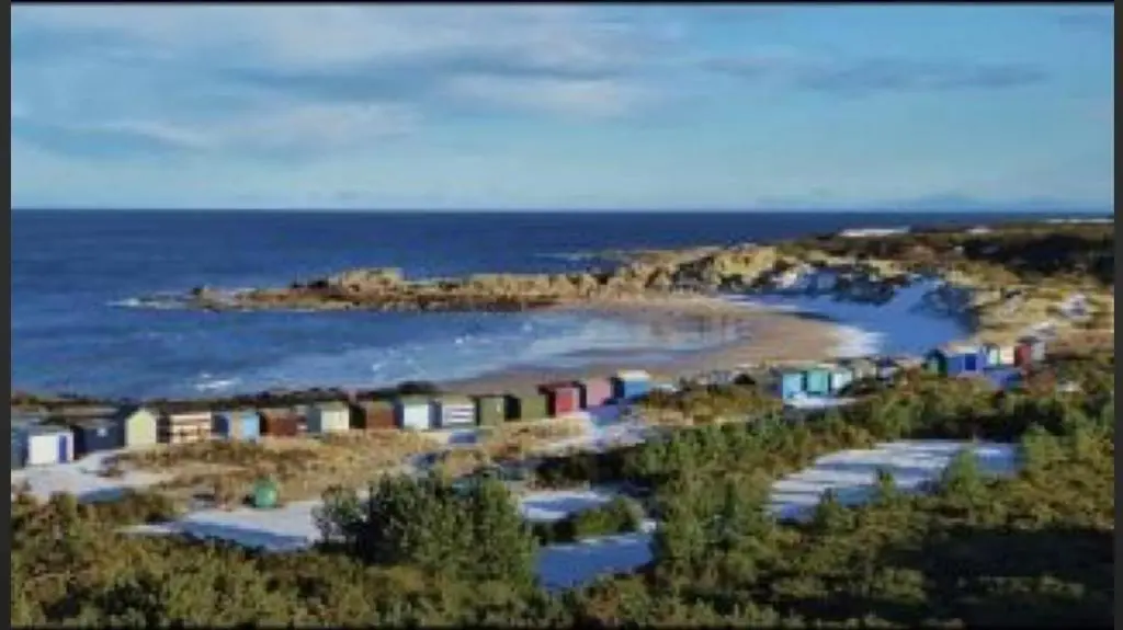 an aerial view of a beach with colorful houses at BalMara in Hopeman