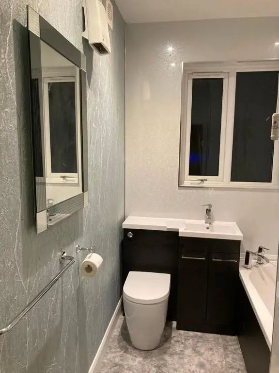 a bathroom with a toilet and a sink at BalMara in Hopeman