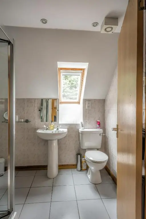 a bathroom with a toilet and a sink at Lann Dearg Studios in Invermoriston
