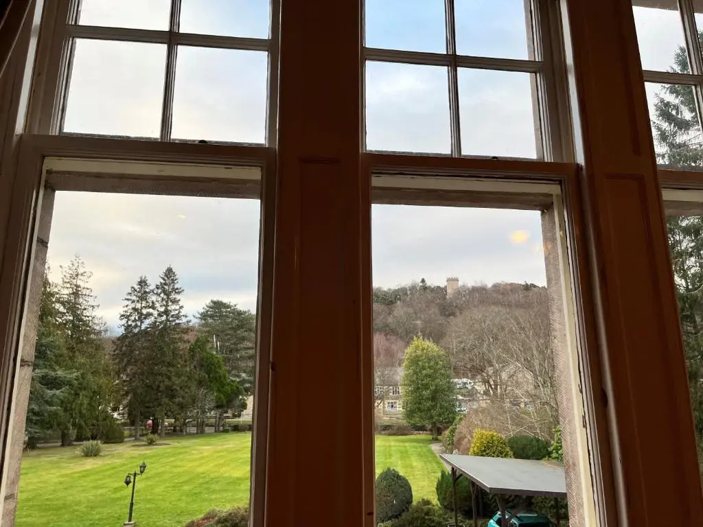 an open window with a view of a yard at Ramnee Hotel in Forres