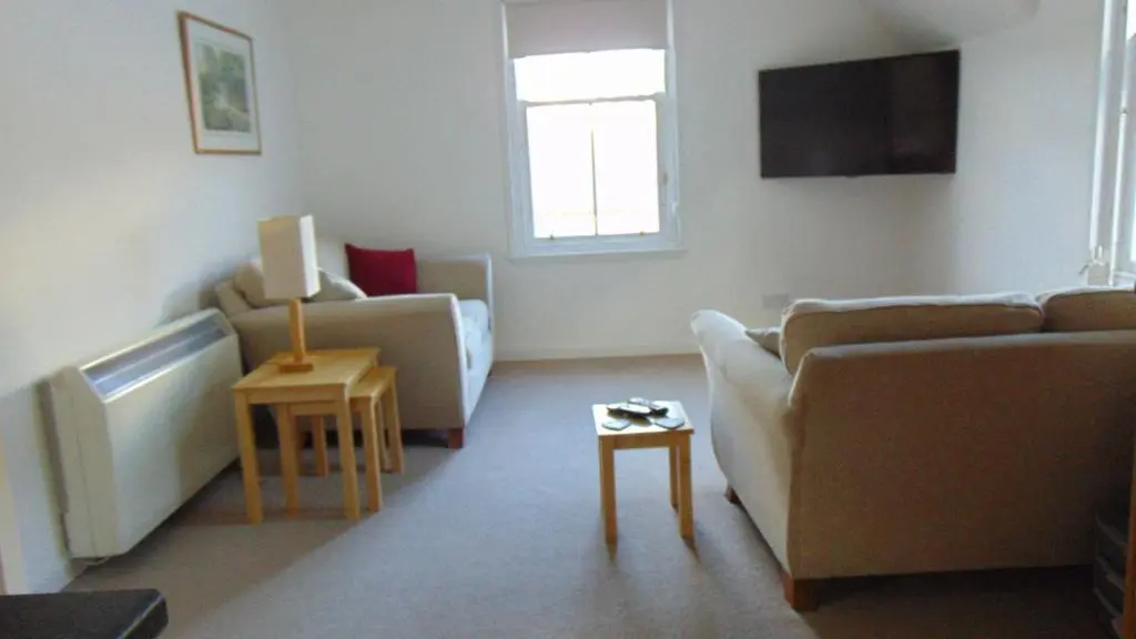 a living room with two couches and a tv at Montclaire in Ballater