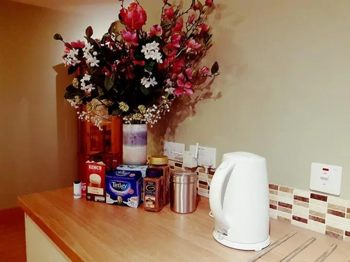 a vase of flowers sitting on top of a counter at Yvi's 2-3 Bedroom Town Apartment in Inverurie