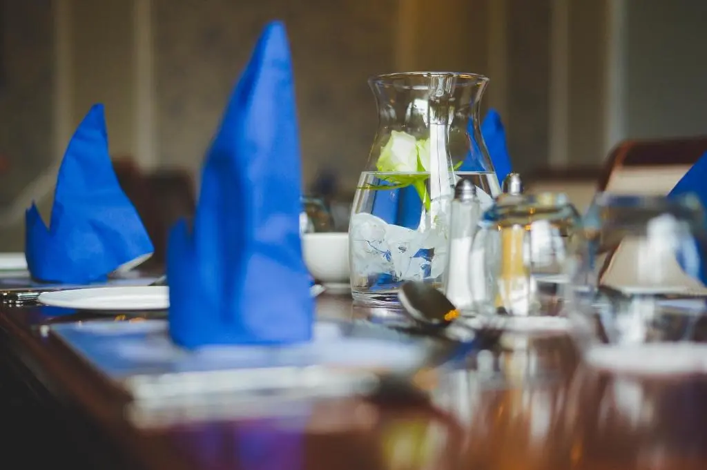 a table with blue napkins on top of a table at Sunninghill Hotel in Elgin