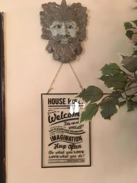 a plaque on a wall with a sign on it at Gordon House in Tomintoul