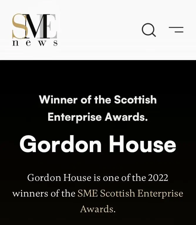 a sign that reads winner of the scottish enterprise awards at Gordon House in Tomintoul