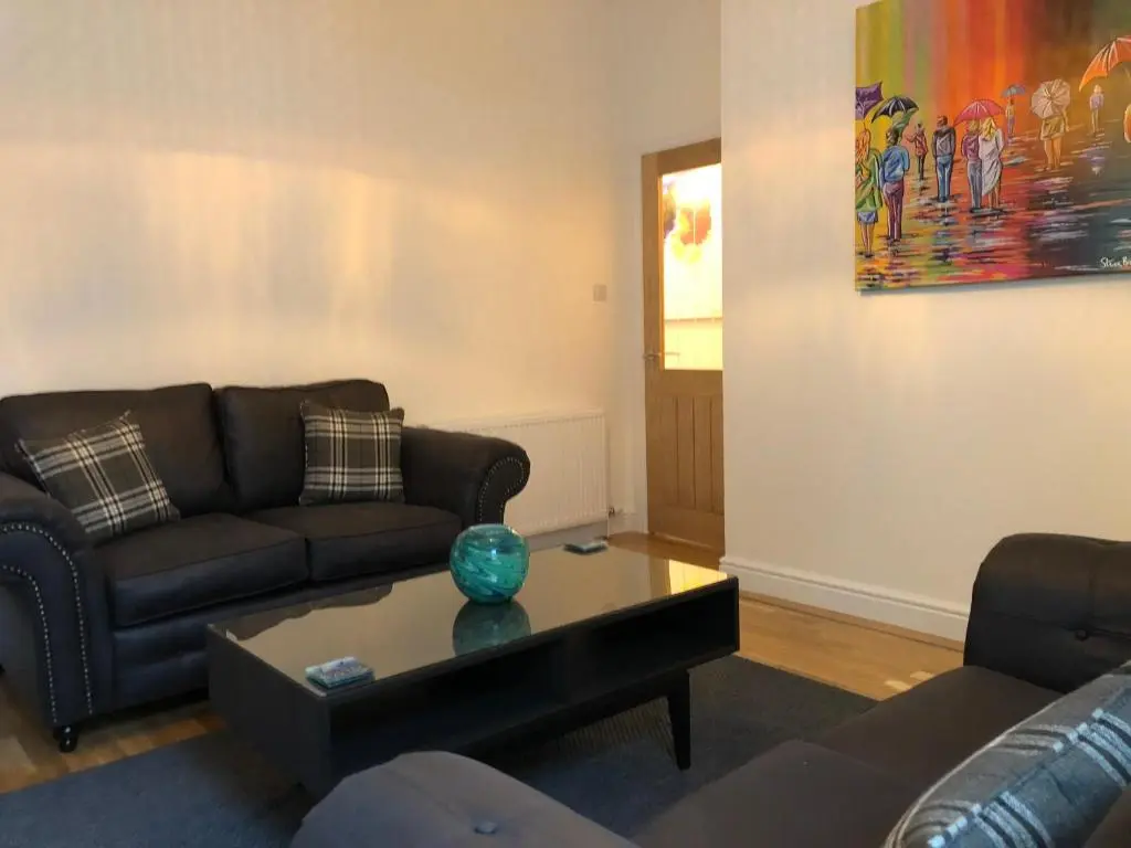 a living room with a couch and a coffee table at Dryburgh Apartment No3 in Inverness