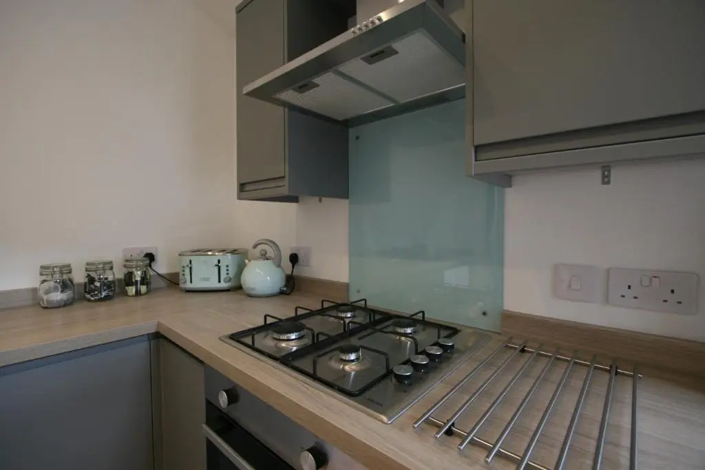 a kitchen with a stove top oven in a kitchen at Dryburgh Apartment No3 in Inverness