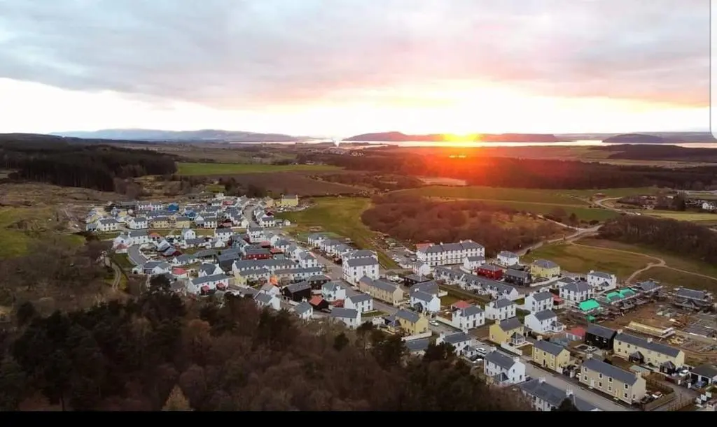 an aerial view of a city at sunset at Olavat Cottage detached property with parking in Inverness