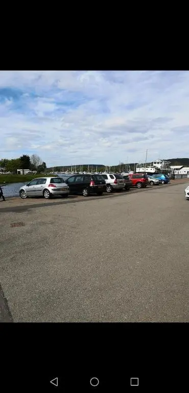 a row of cars parked in a parking lot at Caledonian Canal Studio in Inverness
