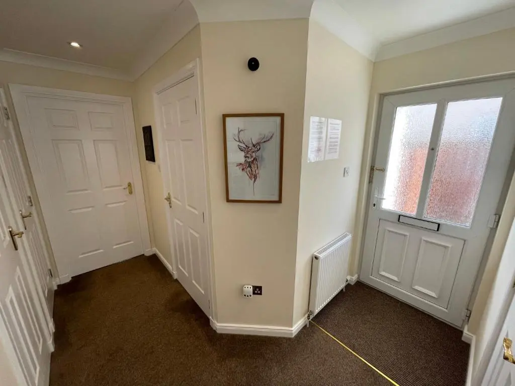 a hallway with two white doors and a window at Holm from Home in Inverness
