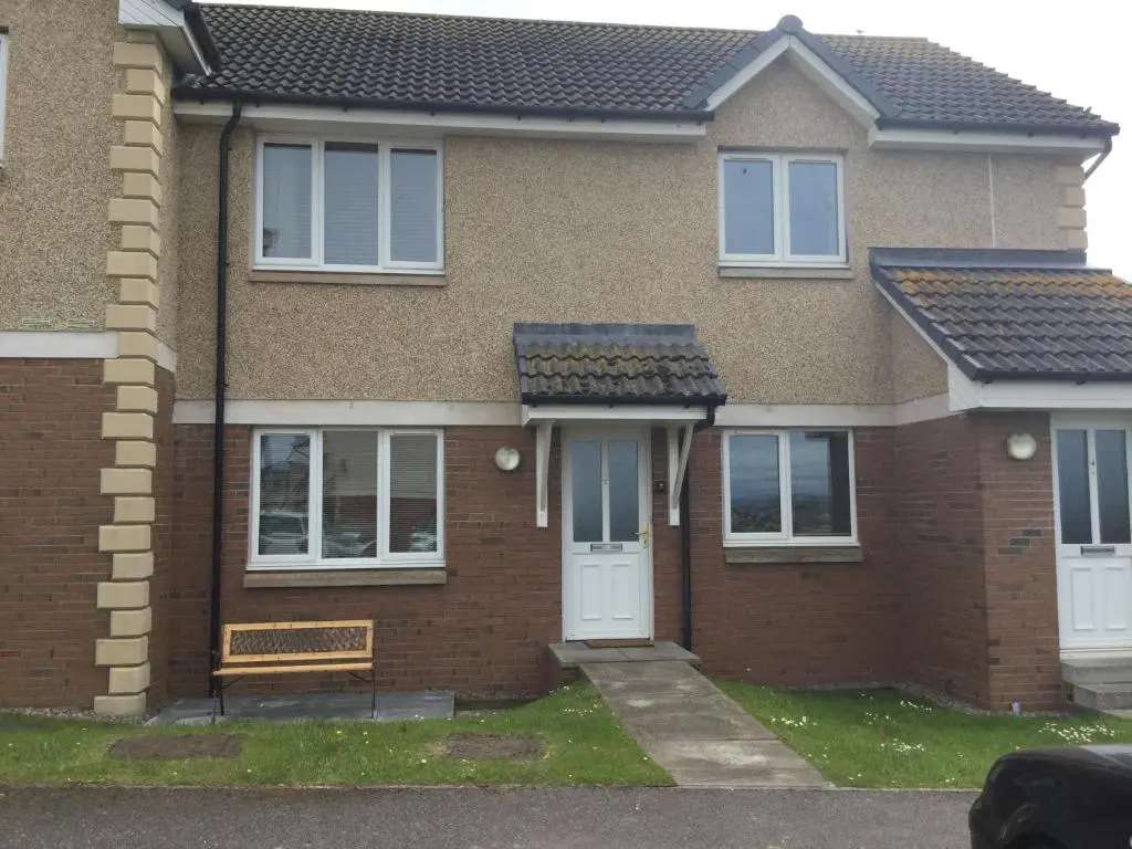 a brick house with a bench in front of it at Morning Field Apartment Free Parking in Inverness
