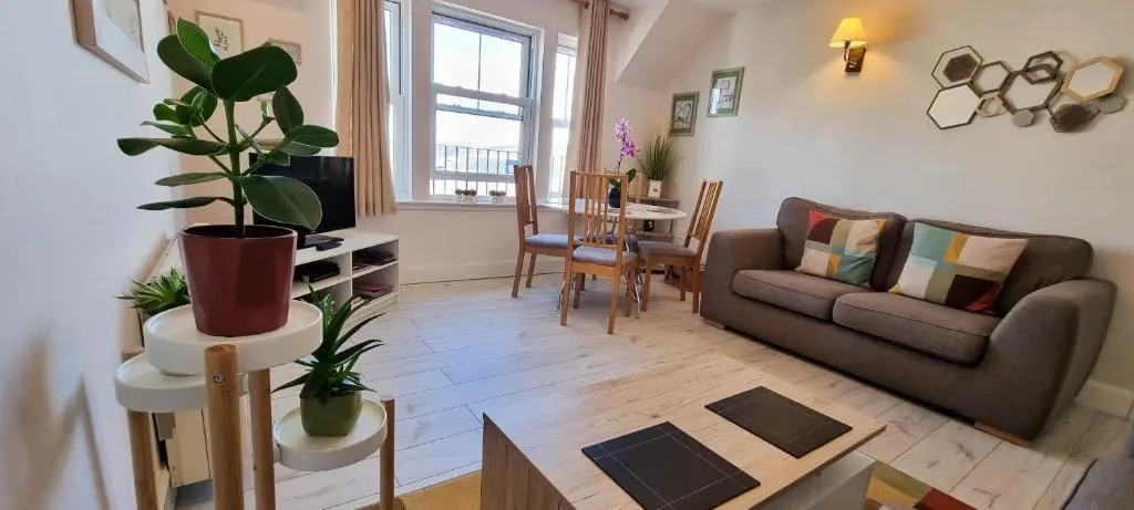 a living room with a couch and a table at Heart of Inverness-city apartment in Inverness